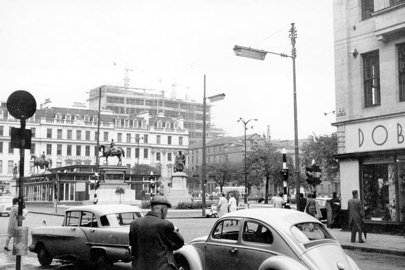 A street scene captured from Queen Street of George Square with the Glasgow College of Building and Printing under construction in the background on North Hanover Street. The building was opened in 1964 by Labour leader Harold Wilson. 