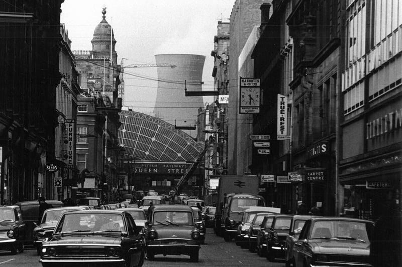 Cars heading down Queen Street during the late-sixties with Pinkston Power Station tower looming in the background. 