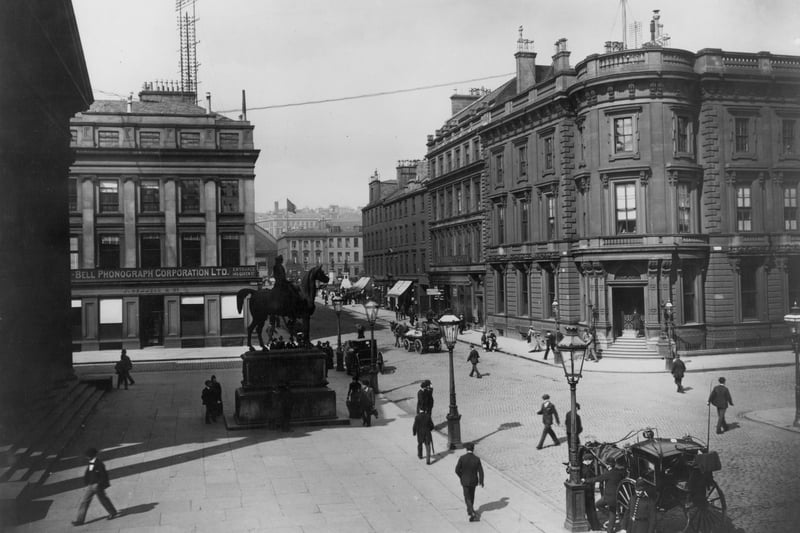 Looking north up Queen Street at Royal Exchange Square with the Duke of Wellington statue and British Linen Bank visible. 