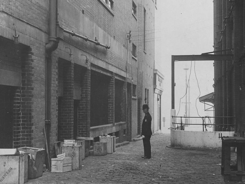 The police officer in this picture is looking at the spot where two bombs were  in a dustbin at the foot of Woolworth's building. The Tower is seen on the right.
Heywood Street, near Woolworth's Blackpool
