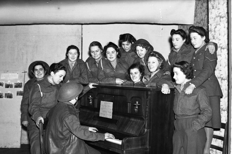 A Christmas singsong around the piano for these Auxiliary Territorial Service members in Sunderland in December 1941.