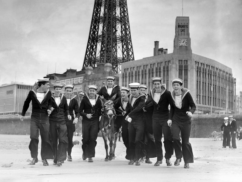 Some of the crew of HMS Blackpool, anchored one mile off Central Pier, were stranded ashore in the town because of high winds and rough seas, 1965