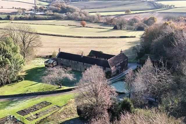 The property includes a summerhouse, kennel, stables, and around 1.75 acres of land. From Bole Hill Lane, a sweeping driveway gives access to Woodend.