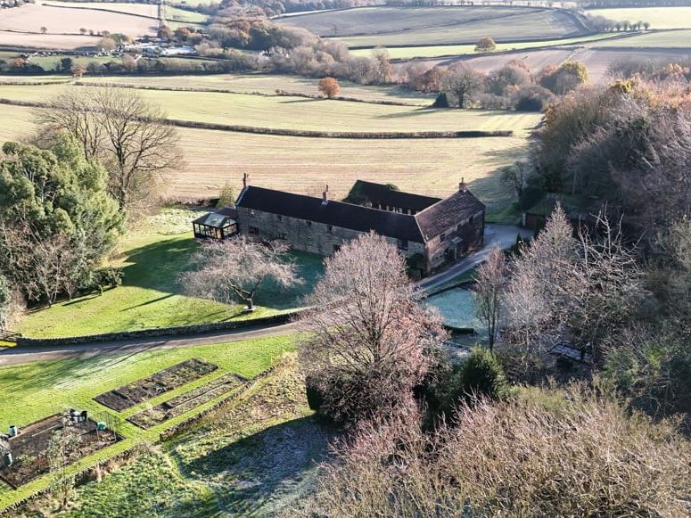 The property includes a summerhouse, kennel, stables, and around 1.75 acres of land. From Bole Hill Lane, a sweeping driveway gives access to Woodend.