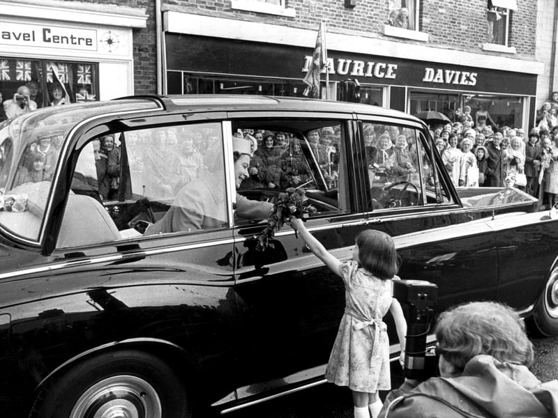 Sonya Wallacy of Garstang, 6, hands flowers to the Queen  / visit to duchy of lancaster