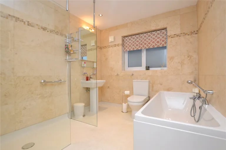 The family bathroom is a spacious room with walk-in shower and separate bathtub.
