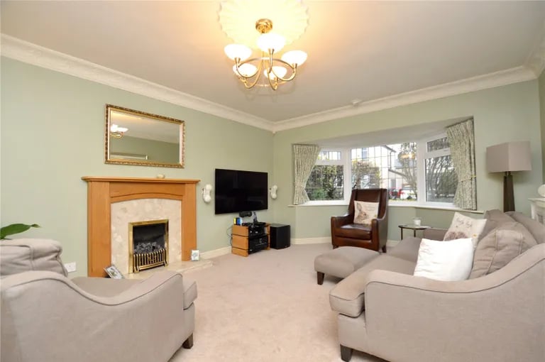 The living room has a bay window to the front elevation and living gas flame fire.