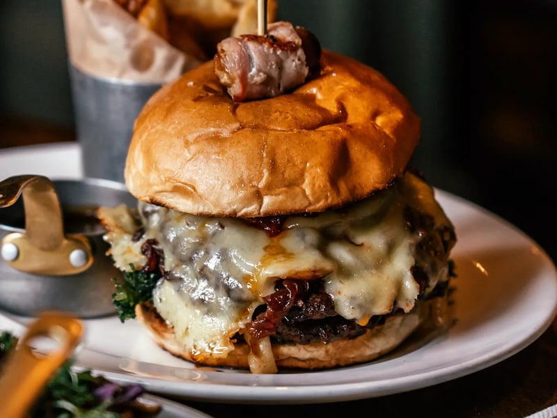 A Christmas classic - The Butchershop Christmas buger. 30 Day Dry Aged steakhouse beef patty, sage and onion stuffing, Ayrshire bacon jam, port and cranberry caramelised onion, sprout tops, Mull cheddar with handcuts and turkey gravy