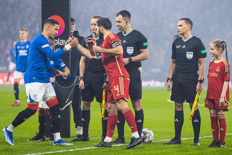 Rangers captain James Tavernier shakes hands and exchanges pennants with Aberdeen skipper Graeme Shinnie ahead of kick-off at a raucous national stadium. 
