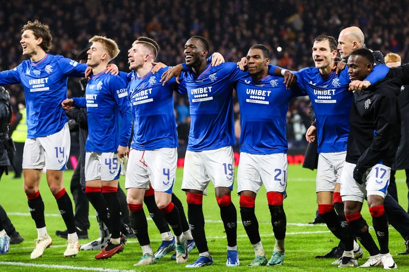 Cue the celebrations as members of the Rangers squad links arms and party in front of their jubilant supporters.