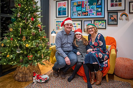 Winning family Katie, Jamies and Katie next to their beautifully decorated Christmas tree.
