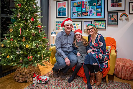 Winning family Katie, Jamies and Katie next to their beautifully decorated Christmas tree.