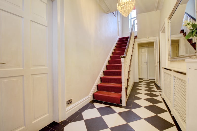 As you step through the door you're greeted by this stunning  hall with tiled floor and high ceilings.