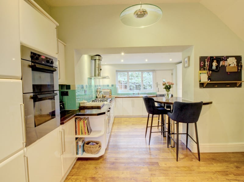 The kitchen also features a delightful breakfast bar and views of the rear garden.