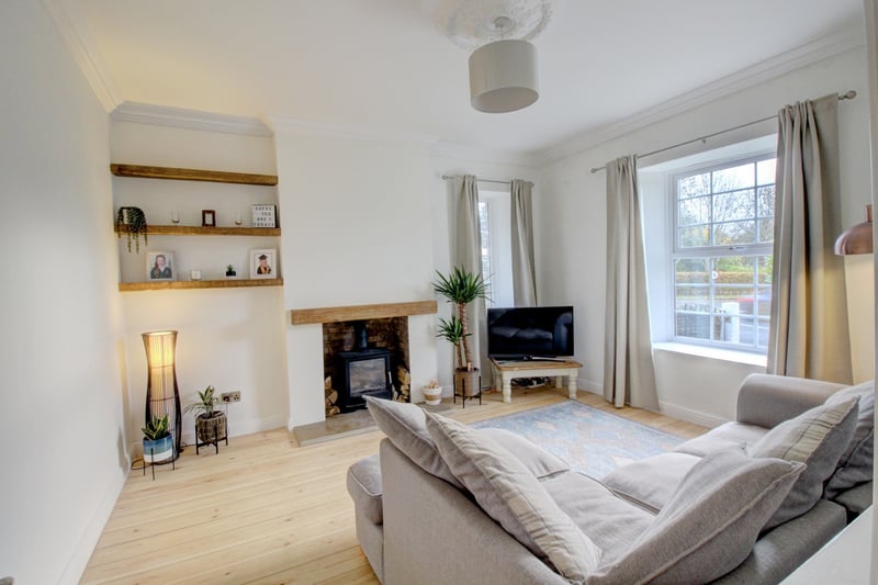 The cosy lounge to the front of the property has a fire place log burner.