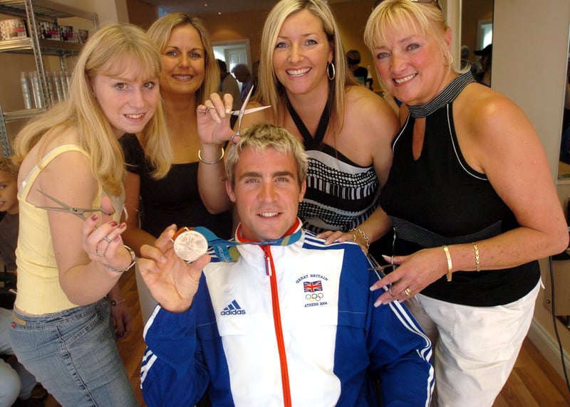 Leon Taylor shows off his Olympic silver medal at the Cutting Room, in Grenoside,  Sheffield, with hairdressers Donna Roebuck, Andrea Marshall, Claire Brothwell and Dorothy Matthewson, in September 2004    