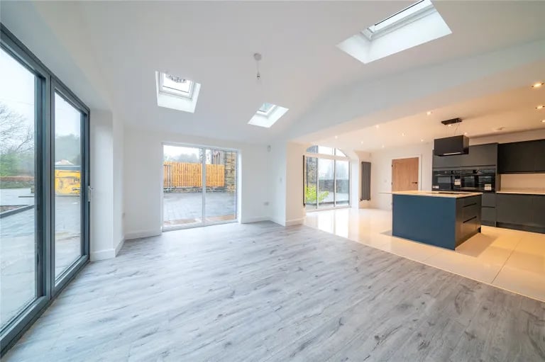 The kitchen opens up to this bright reception room.
