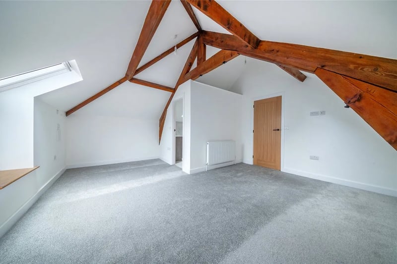 The gorgeous large bedrooms have exposed wood beams in the ceiling.