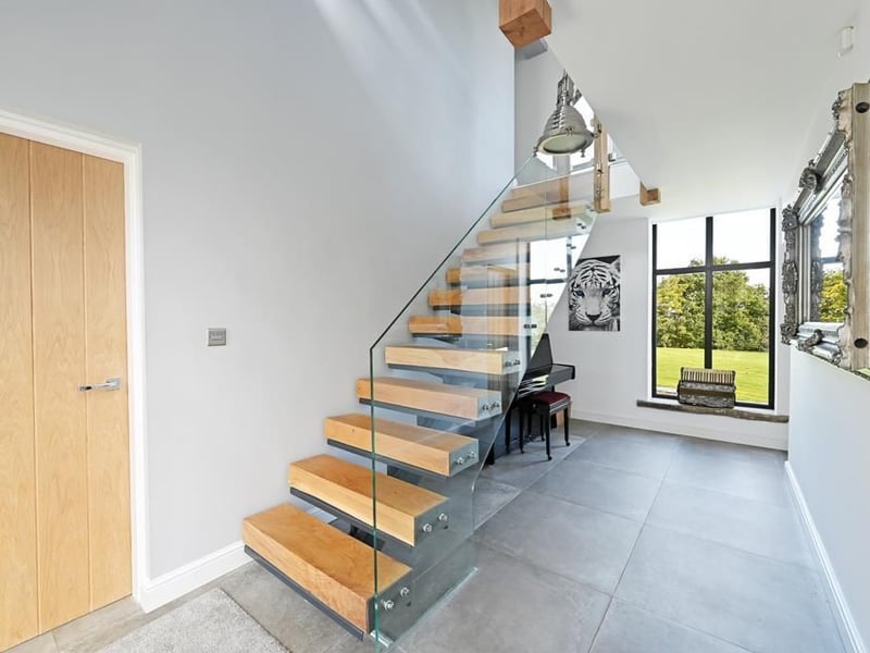 The "contemporary steel and oak" staircase works its way up to the amazing second floor. (Photo courtesy of Zoopla)