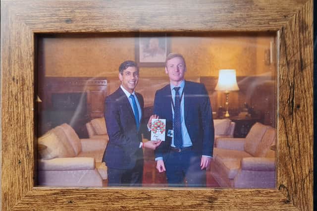 Lee Rowley, MP of North East Derbyshire and Prime Minister Rishi Sunak pictured with Evie's winning Christmas card design.