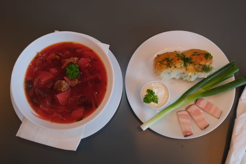 Pictured is borscht, a hot beetroot-based soup, served with a homemade garlic bread known as pampushka.