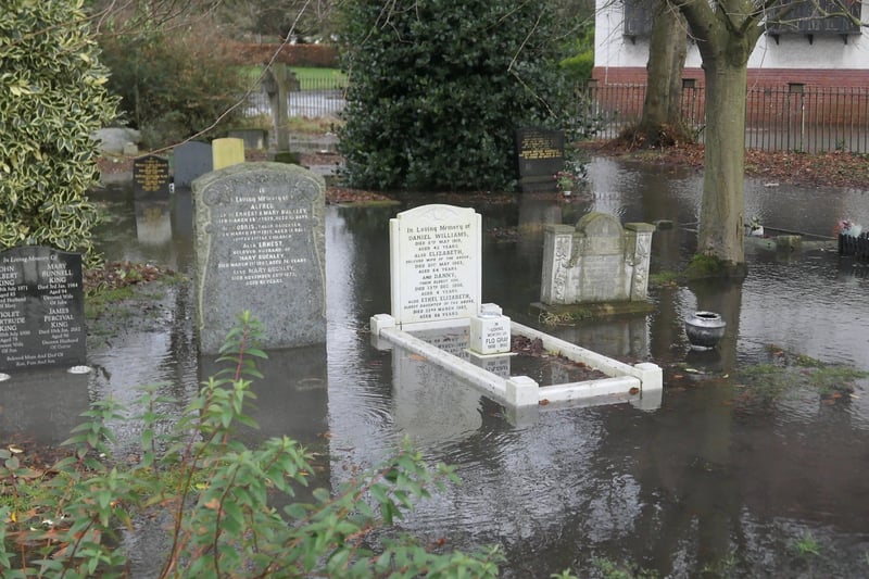 Water fills a Wirral graveyard.