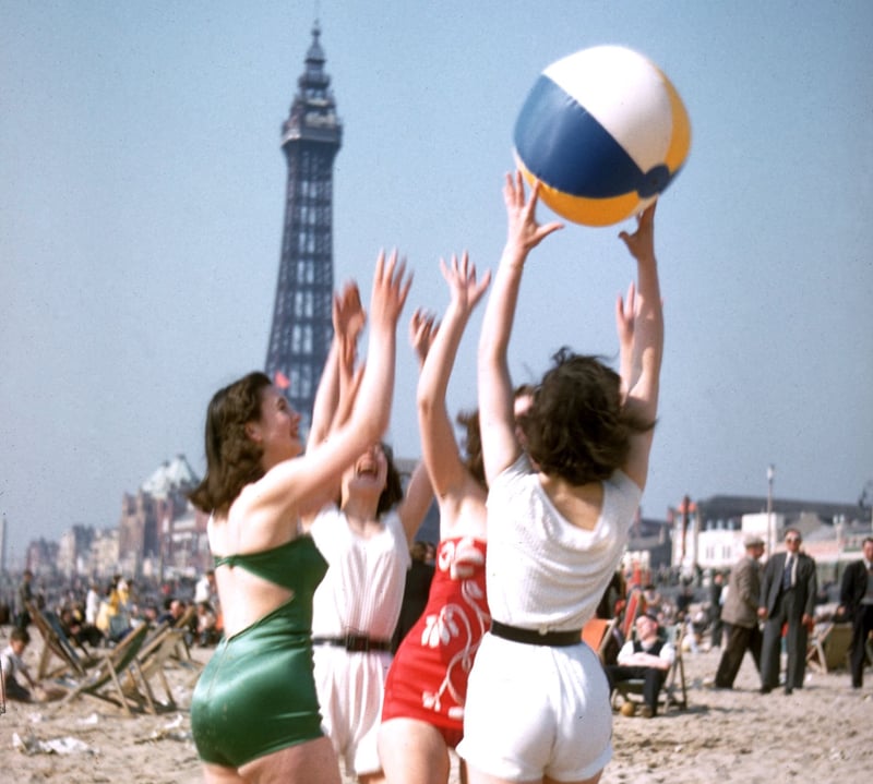 23rd June 1955:  A group of young women play with a beach ball on Blackpool beach.  (Photo by Hulton Archive/Getty Images)