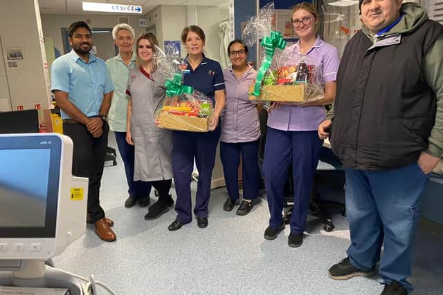 A volunteer from Darnall Foodbank gives one of their Christmas hampers to NHS staff.