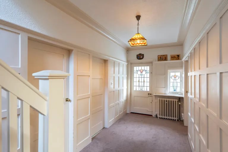 It takes you into a bright and spacious entrance hall.