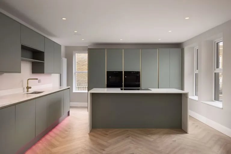 The kitchen is fitted with base and wall units and appliances and has a central island.