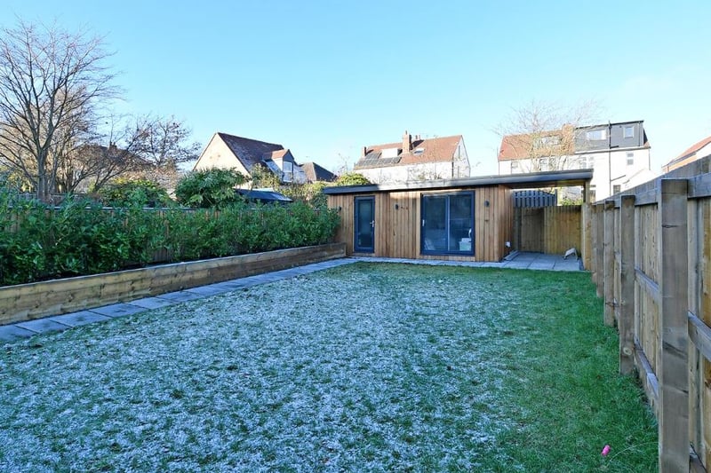 The lawned garden has a garden room office pod at the rear. (Photo Spencer Estate Agents) 
