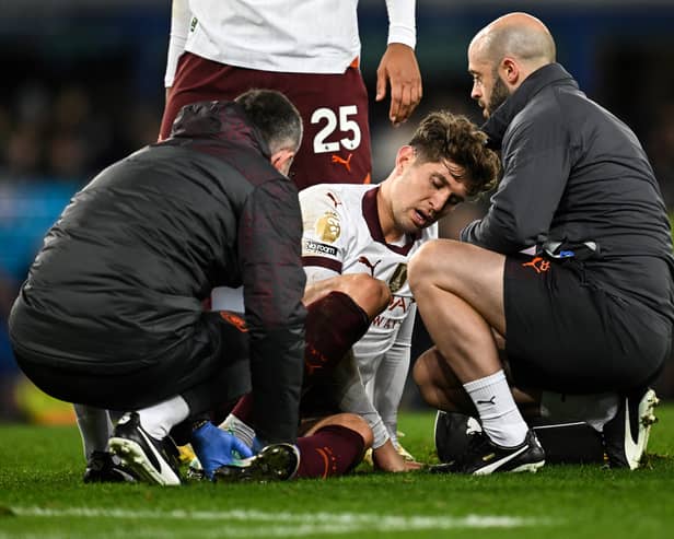 Man City's John Stones receives medical treatment during the match between Everton and Manchester City at Goodison Park, December 27, 2023. (Photo by Paul ELLIS / AFP)