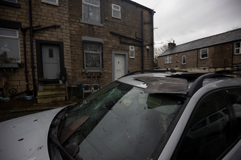 Damaged cars are seen outside a home. Picture: Ryan Jenkinson/Getty Images