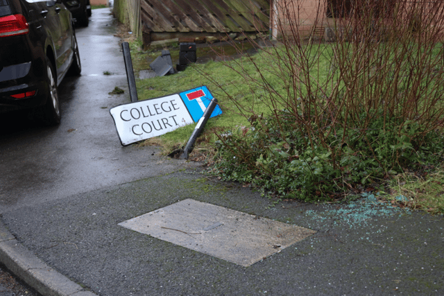 Broken street sign and glass at College Court, Burngreave.
