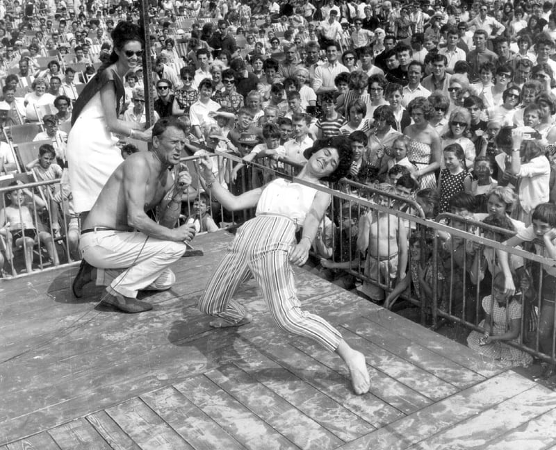 Lonnie Donegan. It's 1962 on a packed and sunlit Central Beach in Blackpool where Ann HAYNES is on the way to winning a limbo-dancing contest