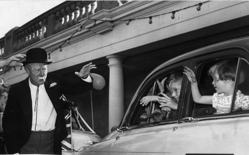The Mayor of Blackpool Ald Clifford Cross JP and Richard Hearne are seen waving goodbye to children from  Blackpool who were taken on a day's outing to Chester by 14 Red Cab Taxis, 1961
