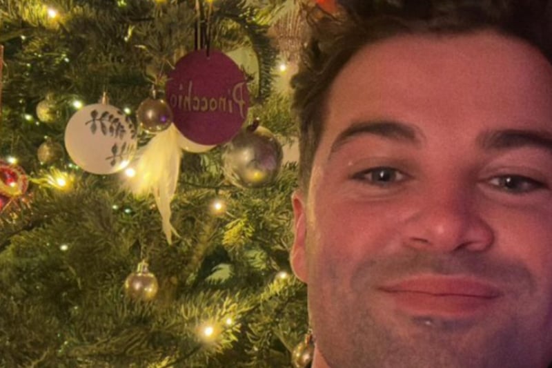 X Factor icon Joe McElderry shared an image of himself next to his Christmas tree, adorned with a Pinocchio bauble - which he is currently starring in.