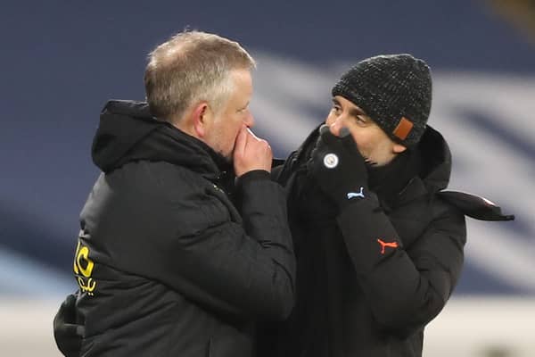 Sheffield United's Chris Wilder (L) greets Manchester City's Pep Guardiola (R) at the end of the Premier League match between Manchester City and Sheffield United at the Etihad Stadium in Manchester, north west England, on January 30, 2021. (Photo by Martin Rickett / POOL / AFP) 
