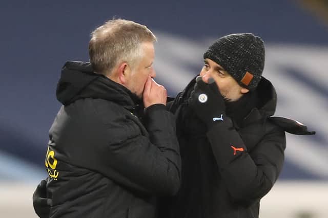 Sheffield United's Chris Wilder (L) greets Manchester City's Pep Guardiola (R) at the end of the Premier League match between Manchester City and Sheffield United at the Etihad Stadium in Manchester, north west England, on January 30, 2021. (Photo by Martin Rickett / POOL / AFP) 