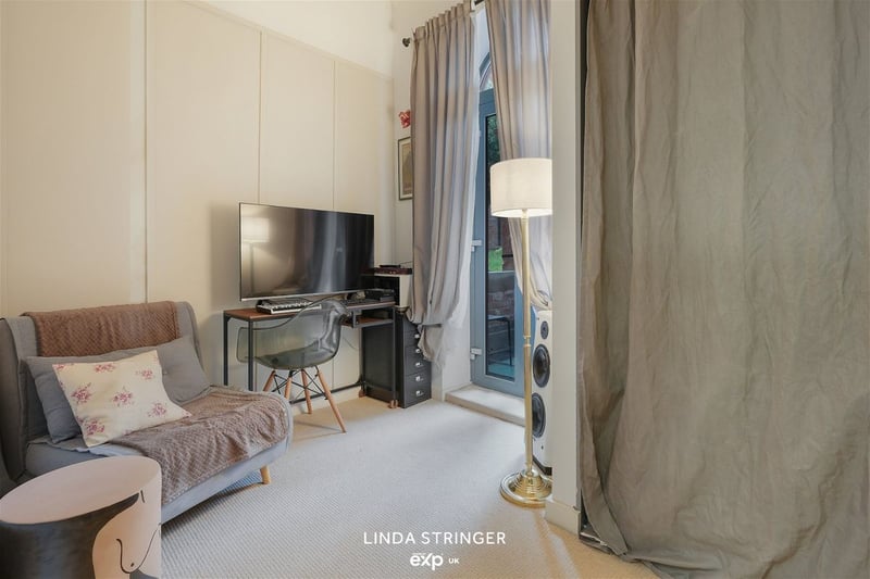 The bedroom on the ground floor has patio style doors leading out to a covered outdoor area. Photo: Zoopla