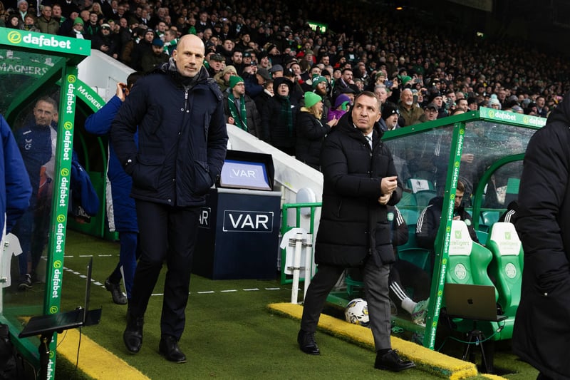 Celtic manager Brendan Rodgers (R) and Rangers boss Philippe Clement (L) walk side-by-side out of the tunnel ahead of kick-off. 