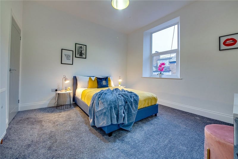 The front-facing, first-floor bedroom has a simple and modern design as well as new carpets.