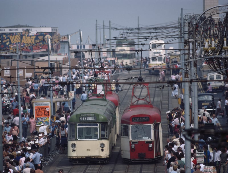 Trams and holidaymakers on the seafront of the seaside resort of Blackpool, Lancashire, August 1983