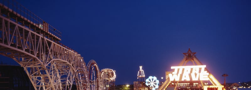 A night view of the illuminated rollercoaster and fun rides including the 'Tidal Wave' at Blackpool Pleasure Beach