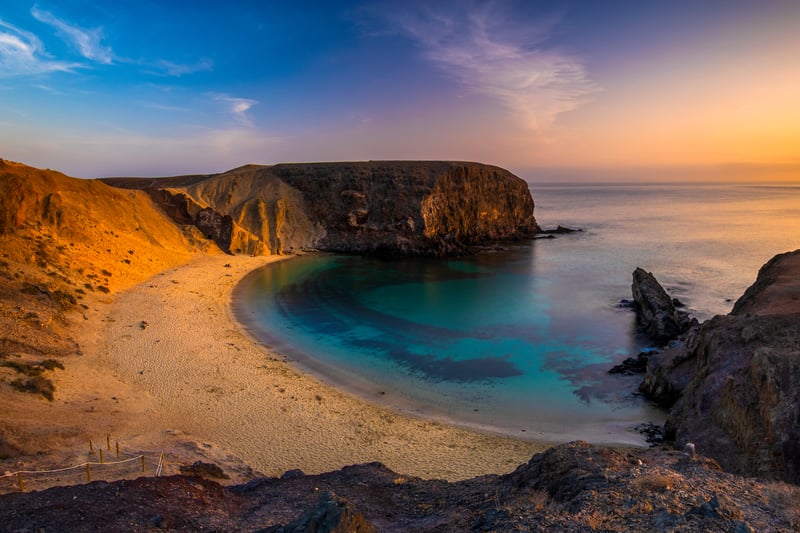 Romantic sunset over the beautiful, natural and sandy beach of Papagayo on Lanzarote