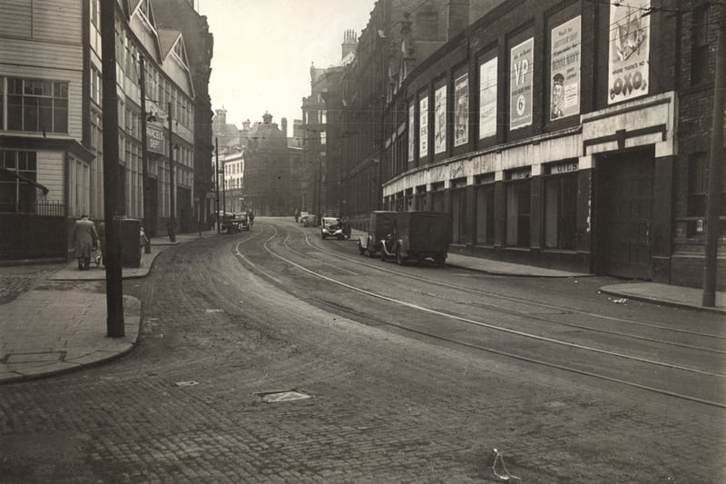 Westgate Road in 1950. The photograph is taken near to its junction with St. Nicholas' street. The building on the left hand side is the Parcels Depot . Various advertising hordings can be seen on the wall to the right these include posters promoting Oxo and the Royal Navy Collection