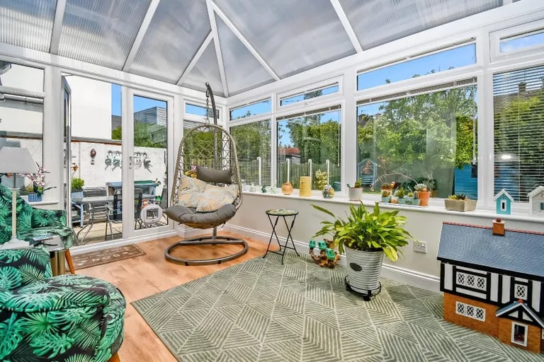 This impressive sun room offers panoramic views of the rear garden flooding in natural light.