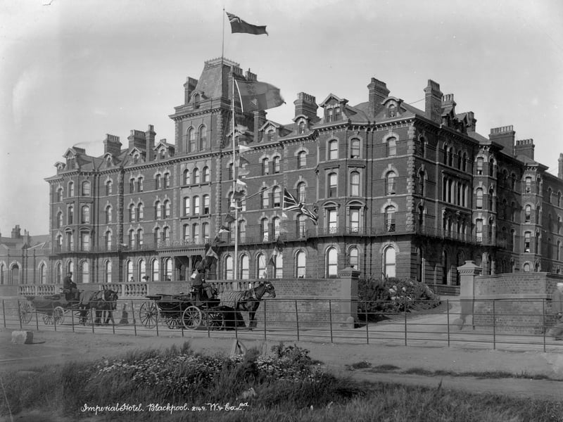 Imperial Hotel, 1890-1910 on a windy day with two horse-drawn carriages parked outside awaiting fares. The hotel was built in 1867-1868 by Clegg and Jones at a cost of £50,000