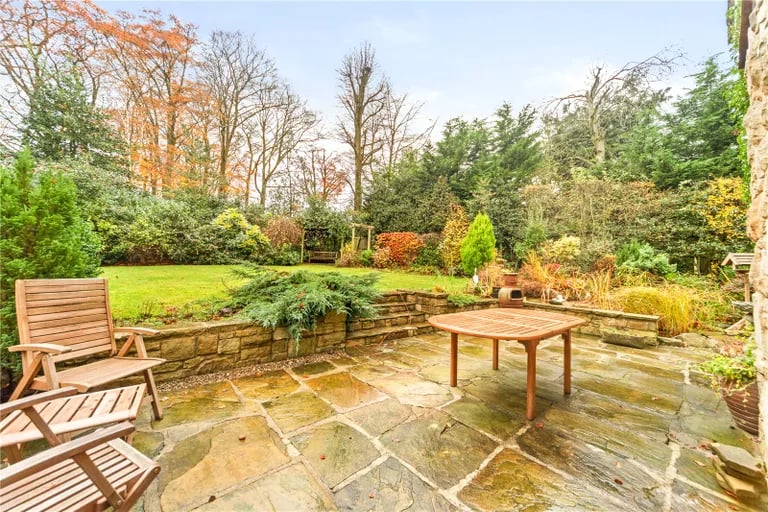 Externally are large green gardens with patio areas for alfresco dining.