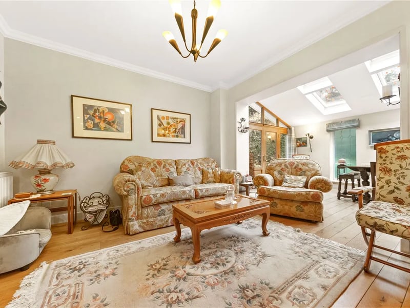 From the kitchen, this dining room currently used as a sitting room grants further access to a garden room.